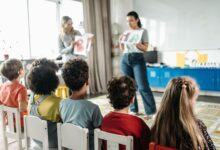 children sitting on white chairs
